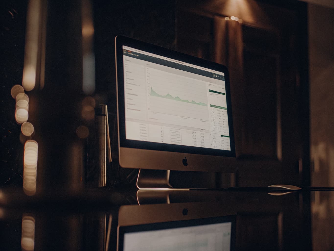 Google Ads management interface on monitor showing campaign performance data